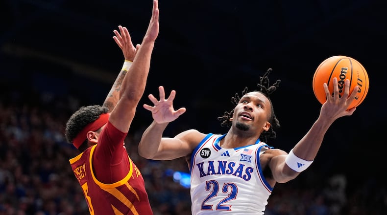 Kansas guard Darryn Peterson (22) shoots over Iowa State forward Joshua Jefferson (5) during the first half of an NCAA college basketball game Tuesday, Jan. 13, 2026, in Lawrence, Kan. (AP Photo/Charlie Riedel)