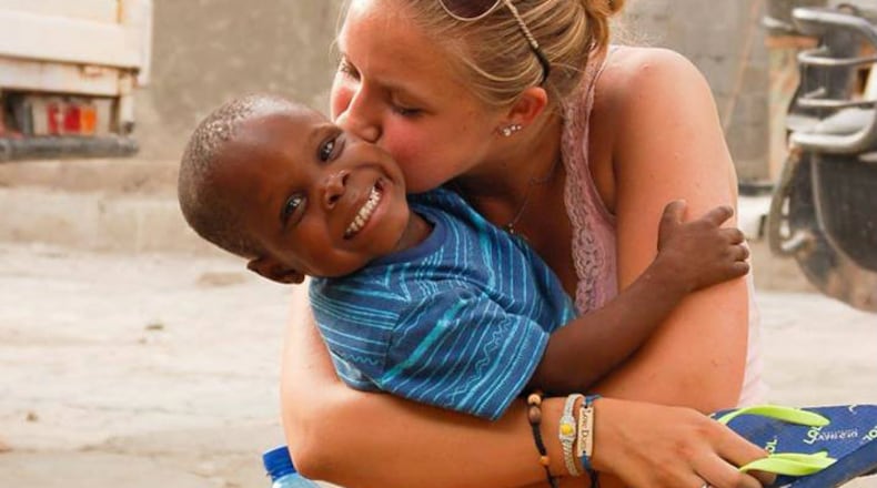 Stephanie Cleland gets a big hug from Jeremie, a 5-year-old orphan from Haiti. Stephanie and her brother Jaden and trying to help bring Jeremie to the United States so that he can receive the education he would otherwise not get in his native country. Jeremie was abandoned by his family because his is deaf. CONTRIBUTED