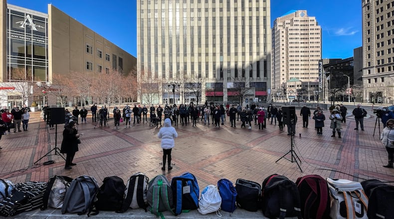 Backpacks filled with item for Dayton's homeless population line the stage at Courthouse Square Tuesday. The memorial for the homeless in Montgomery County was held Tuesday Dec. 21, 2021. JIM Noelker/STAFF