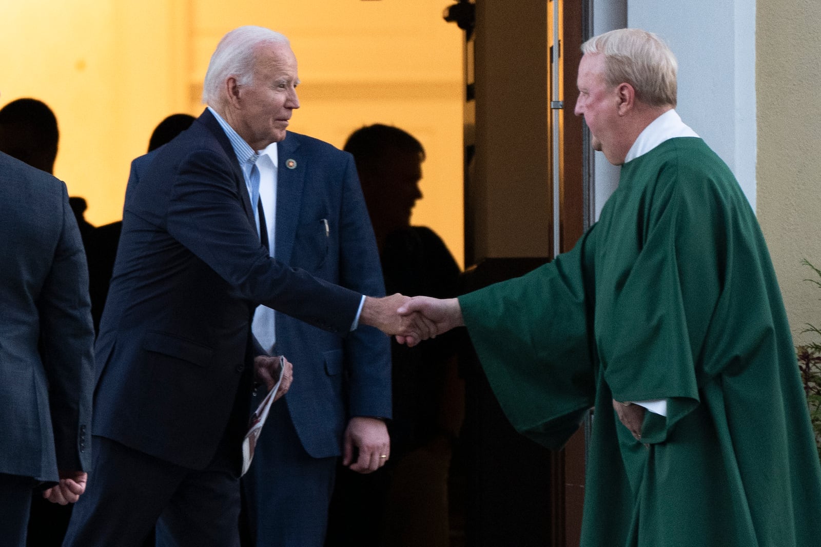 FILE - President Joe Biden, left, is greeted by a priest as he leaves St. Joseph on the Brandywine Catholic Church in Wilmington, Del., after attending a mass, Nov. 2, 2024. (AP Photo/Manuel Balce Ceneta, File)