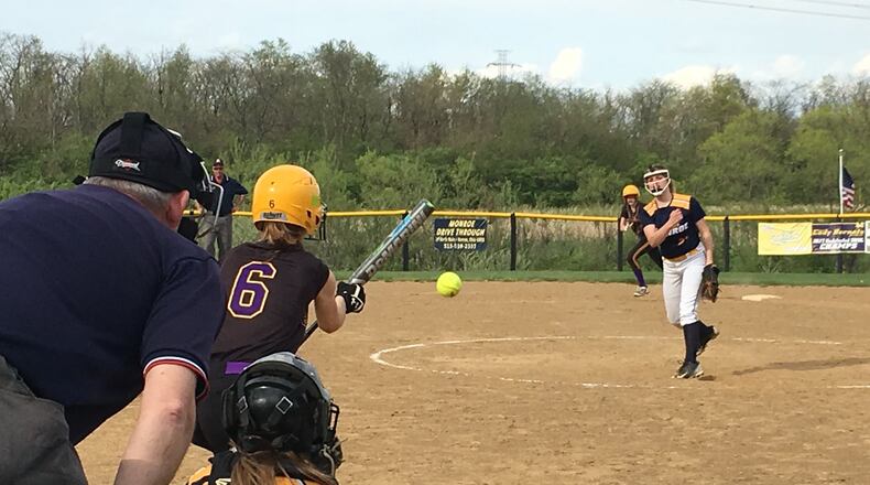 Monroe’s Alyssa Wagner delivers a pitch toward catcher Sam Schwab as Bellbrook’s Savannah Geldbaugh (6) prepares to bunt during Thursday’s game at Monroe. RICK CASSANO/STAFF