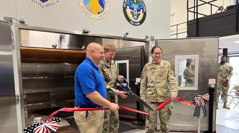 Brig. Gen. Robert K. Bogart, center, cuts the ribbon on the new Research Environmental Chamber at the Air Force Research Laboratory at Wright-Patterson Air Force Base on May 27, 2025. THOMAS GNAU/STAFF