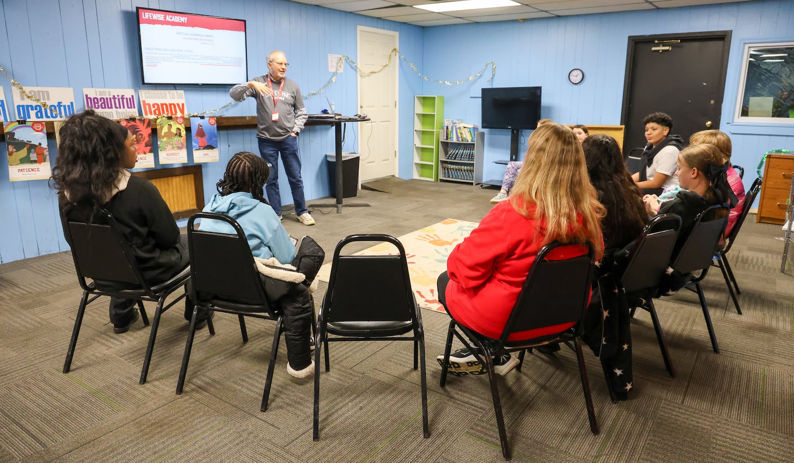 Rich Hall (top left), a LifeWise Academy teacher, talks to a group of Ruskin Elementary School students on Tuesday, Jan. 6, at a Dayton church. LifeWise, which is headquartered in Hilliard, is an organization that offers Christian education to public school students during school hours at sites near school buildings. BRYANT BILLING/STAFF