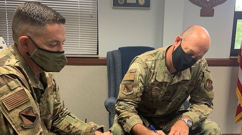 Col. Patrick Miller (right), 88th Air Base Wing and installation commander, and Chief Master Sgt. Jason Shaffer, 88 ABW command chief, are seen wearing the new Operational Camouflage Pattern uniform last August. U.S. AIR FORCE PHOTO/STACEY GEIGER