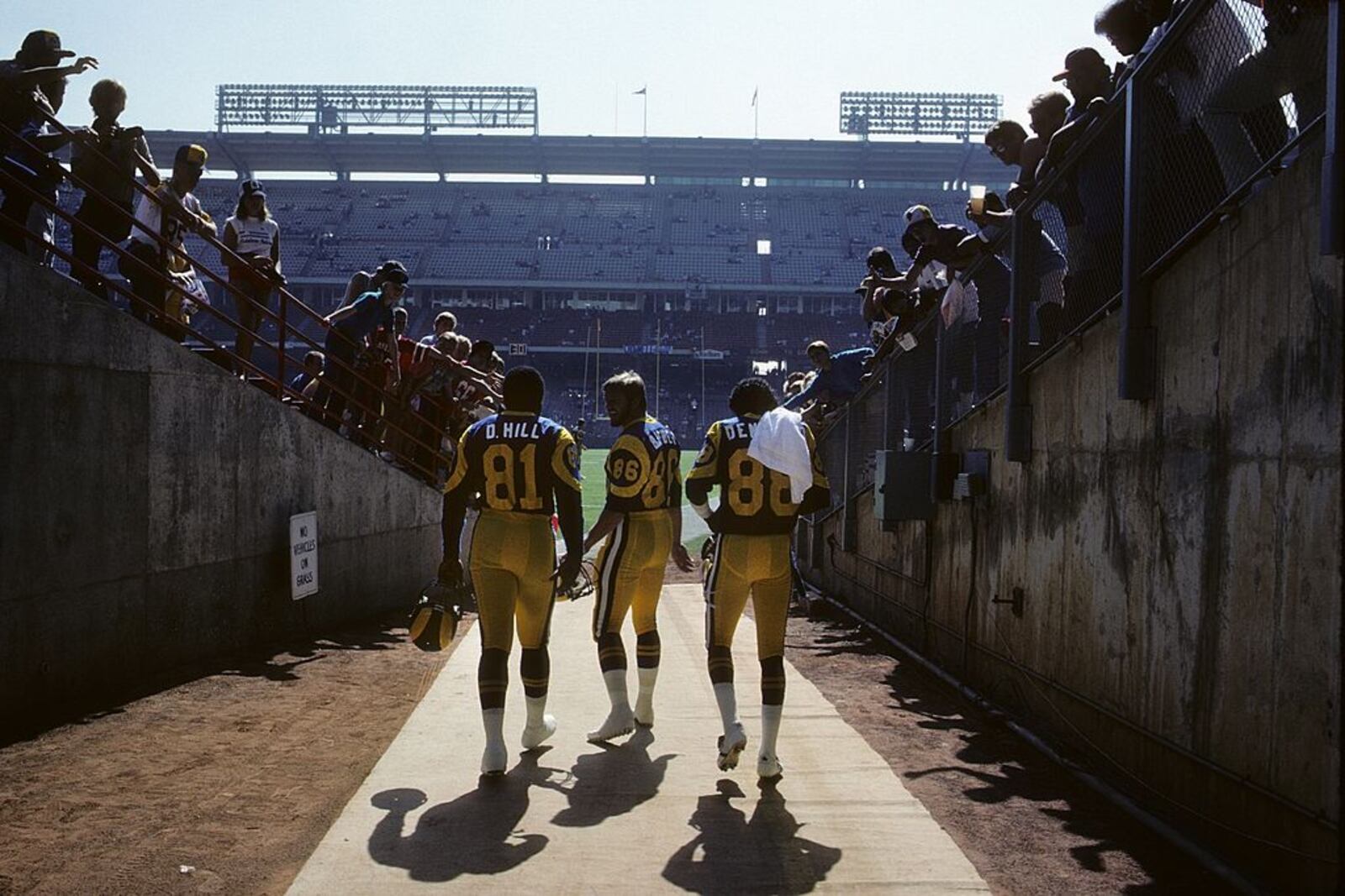 ANAHEIM, CA - OCTOBER 23: Tight ends David Hill #81, Mike Barber #86 and wide receiver Preston Dennard #88 of the Los Angeles Rams take the fiend for pregame warm-ups before the game against the San Francisco 49ers at Anaheim Stadium on Ocotber 23, 1983 in Anaheim, California. The 49ers won 45-35. (Photo by George Rose/Getty Images)