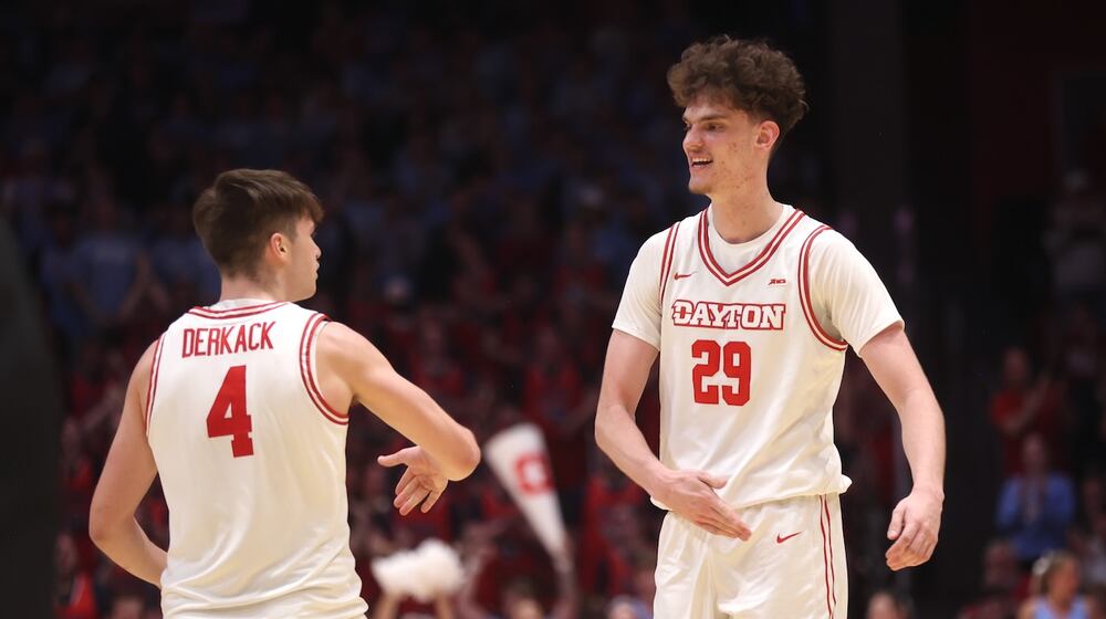 Dayton's Jordan Derkack, left, and Amaël L'Etang celebrate a against Saint Louis on Tuesday, Feb. 24, 2026, at UD Arena. David Jablonski/Staff