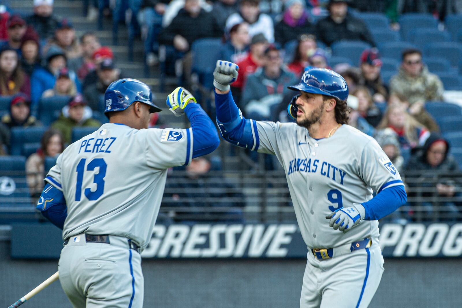 Kansas City Royals' Salvador Perez (13) congratulates Vinnie Pasquantino (9) for his solo home run off Cleveland Guardians starting pitcher Luis Ortiz (45) during the fourth inning of a baseball game in Cleveland, Saturday, April 12, 2025. (AP Photo/Phil Long)