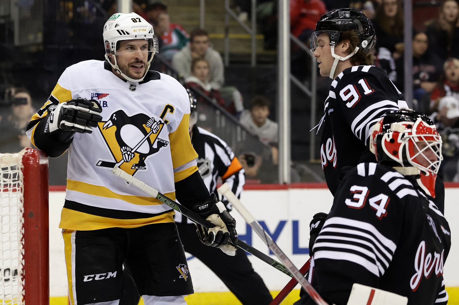 Pittsburgh Penguins center Sidney Crosby (87) reacts after scoring a goal past New Jersey Devils goaltender Jake Allen in the third period of an NHL hockey game Friday, April 11, 2025, in Newark, N.J. (AP Photo/Adam Hunger)