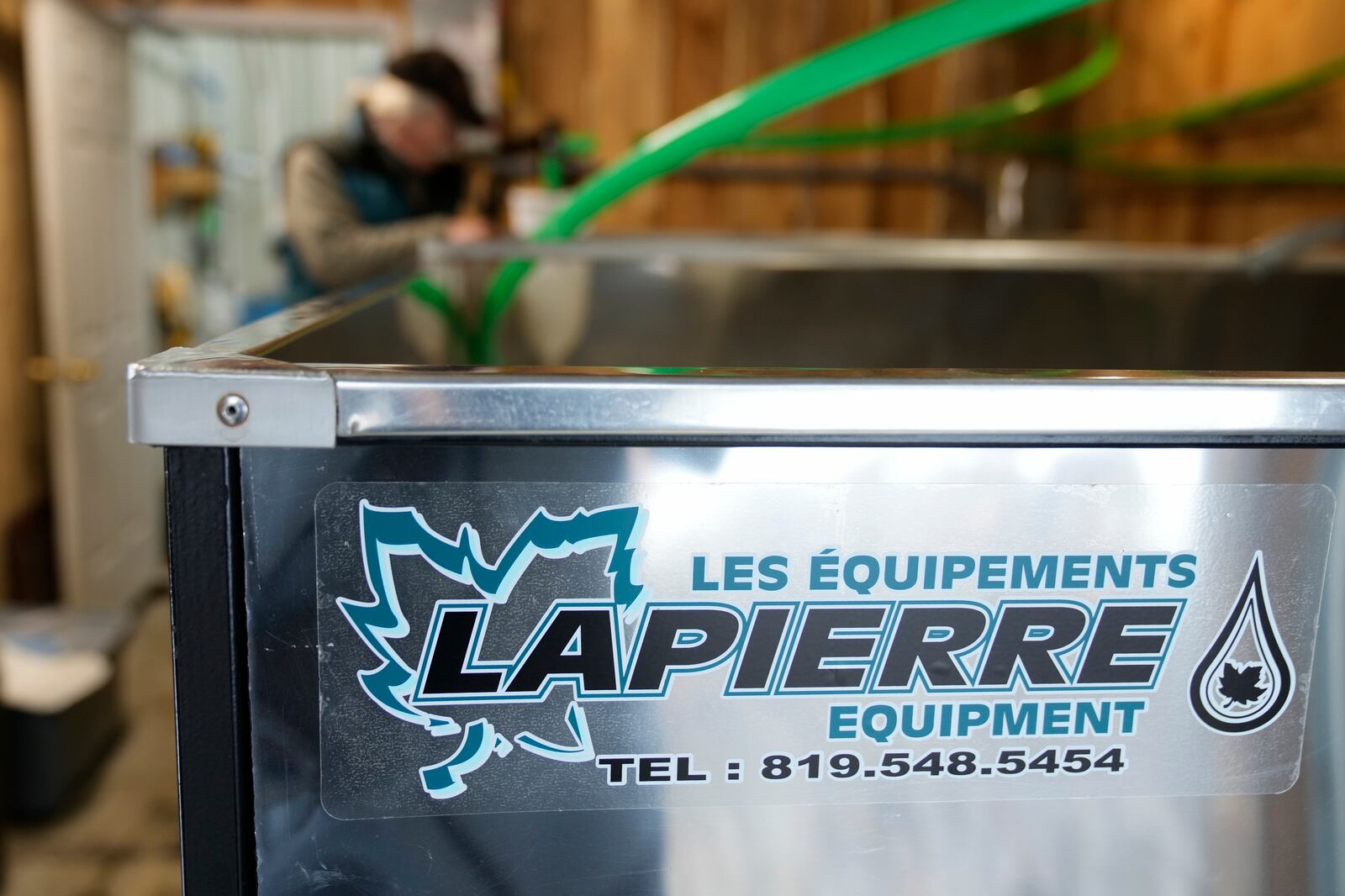 Maple syrup producer Jim Judd checks on the levels of sap in a stainless steel tank imported from Quebec, Canada, at Judd's Wayeeses Farms in Morgan, Vt., on Friday, April 11, 2025. (AP Photo/Robert F. Bukaty)