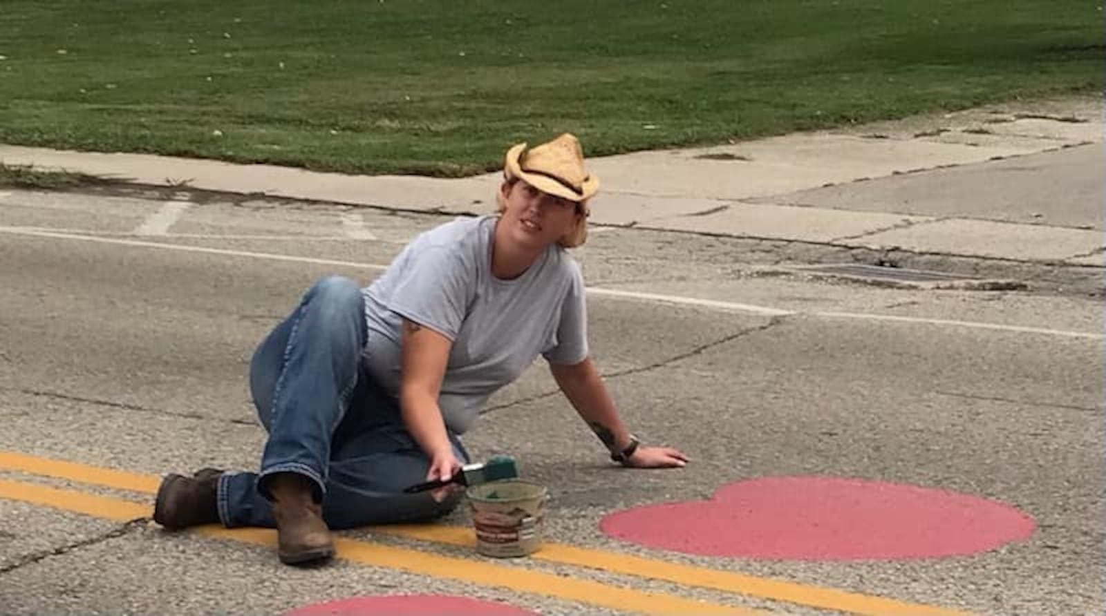 Jessi Devore chairman of Apple Butter Festival paints all the apples on the streets of Enon. CONTRIBUTED