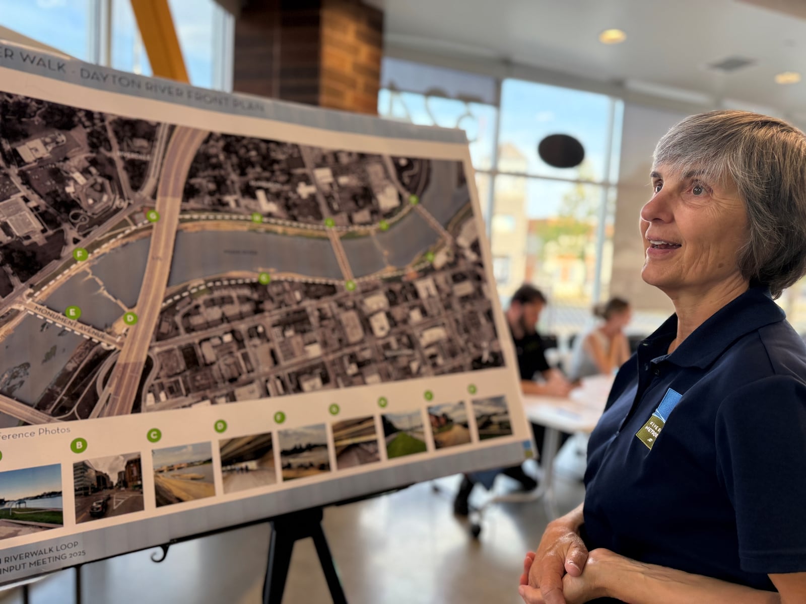 Carrie Scarff, chief of planning with Five Rivers MetroParks, talks with community members about the River Walk trail in downtown Dayton and potential changes and improvements. CORNELIUS FROLIK / STAFF
