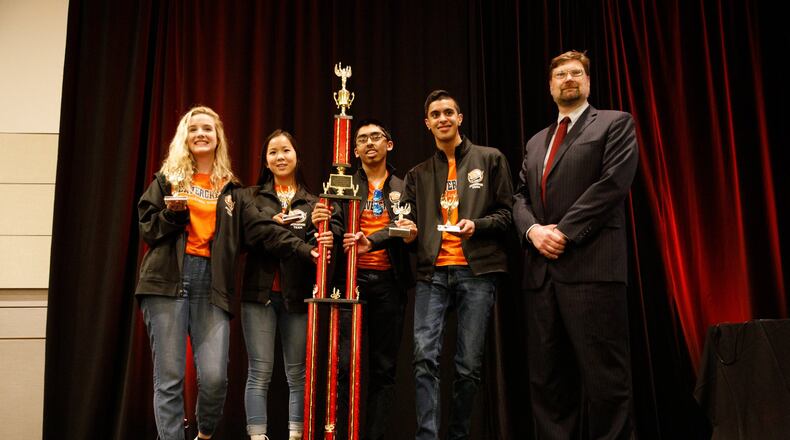 Members of the Beavercreek Quiz Bowl Team hold the trophy after winning the national championship. CONTRIBUTED