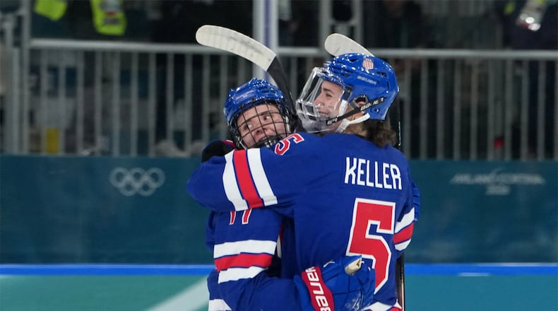 United States' Britta Curl (17) celebrates with Megan Keller (5) after Curl scored a goal against Italy during the second period of a women's ice hockey quarterfinal match at the 2026 Winter Olympics, in Milan, Italy, Friday, Feb. 13, 2026. (AP Photo/Carolyn Kaster)