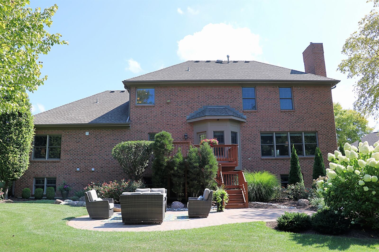 The bay bump-out breakfast room opens to a wooden balcony deck that has steps down to a paver-brick patio surrounded by a privacy garden with water fountain. CONTRIBUTED PHOTO BY KATHY TYLER