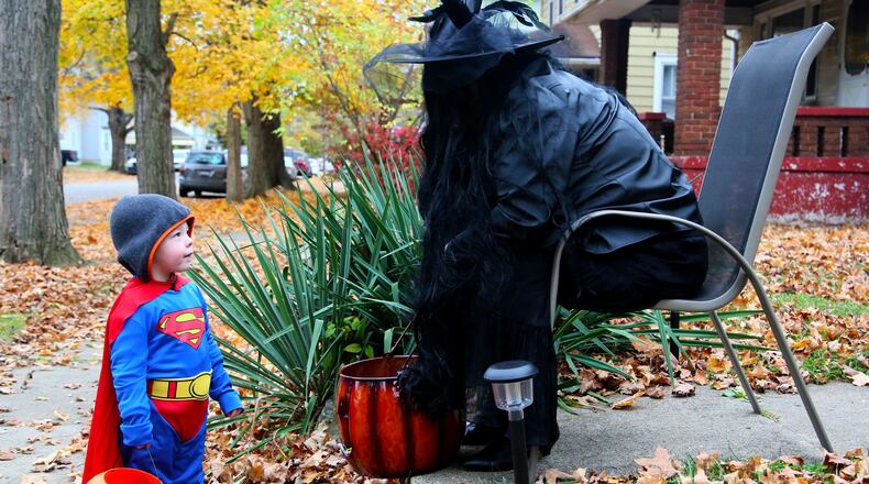 Colt Phillips, 2, dressed as Superman while trick-or-treating past Carol Hauser's house on Franklin St. in Middletown, Saturday, Oct. 31, 2015. GREG LYNCH / STAFF