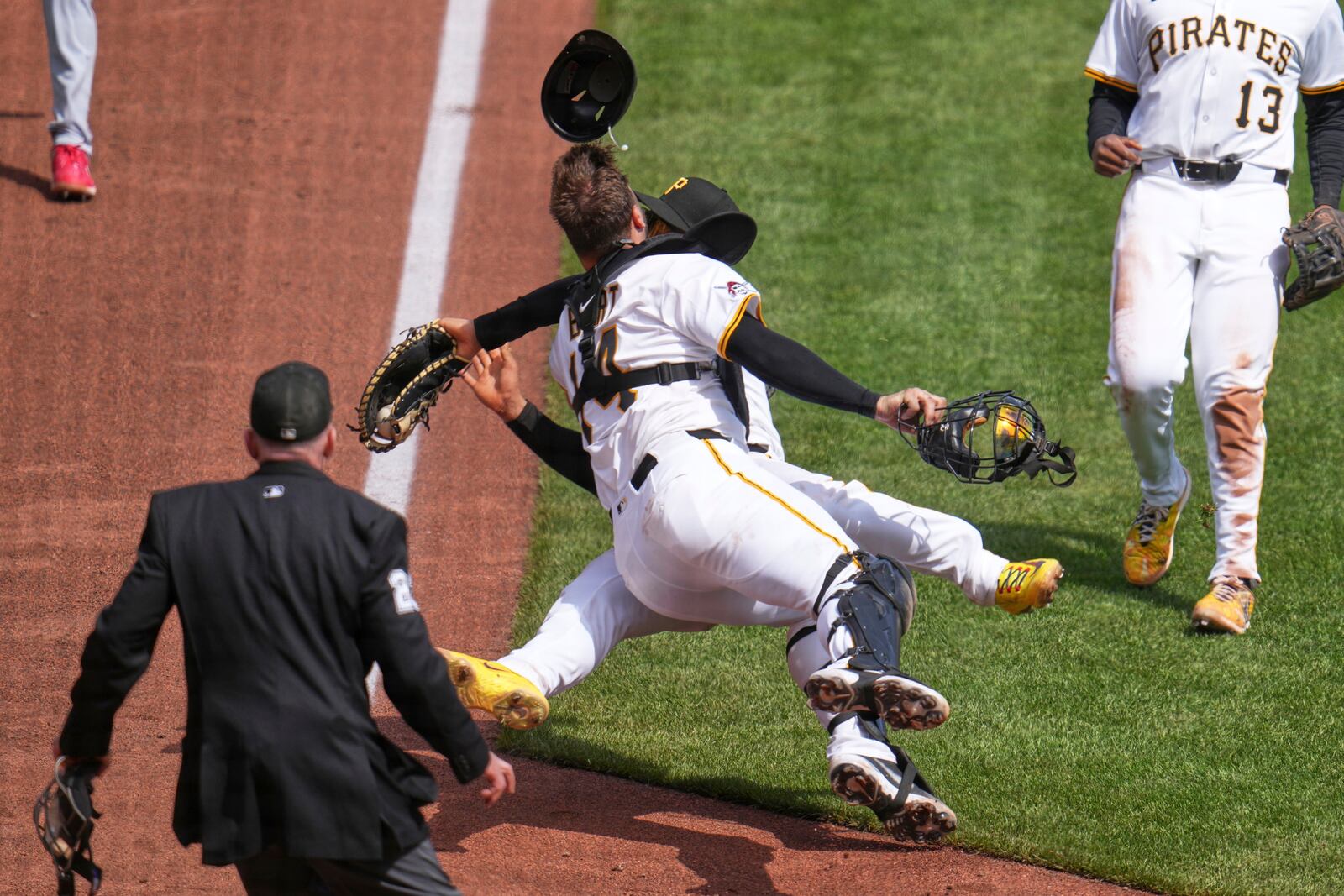 Pittsburgh Pirates first baseman Endy Rodríguez, rear, collides with catcher Joey Bart as they both attempt to field an infield pop-up by St. Louis Cardinals' Willson Contreras during the eighth inning of a baseball game in Pittsburgh, Wednesday, April 9, 2025. (AP Photo/Gene J. Puskar)
