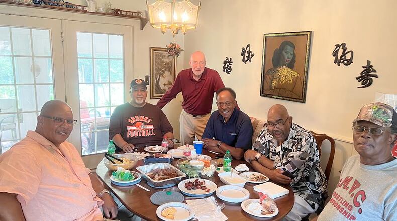 Members of the “Over the River Gang” visit former teacher Jim Wheeler. Tony Currington (from left), Darrell Wright, Jim Wheeler (standing), Lucious Plant, Tim Price and David Cooper share memories. Contributed