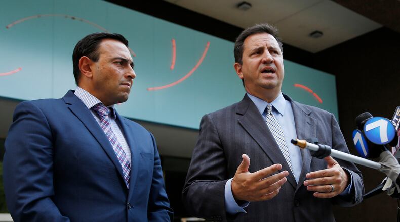Attorney Nick Gounaris, right, and co-counsel Tony Abboud speak after a hearing in Federal Court for their client Ethan Kollie who was charged with lying on a federal firearms form. Kollie was a friend of the Oregon District shooter. TY GREENLEES / STAFF