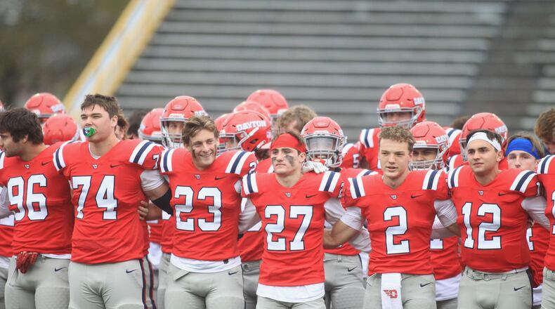 Dayton players celebrate a victory against Butler on Saturday, Oct. 30, 2021, at Welcome Stadium. At left is A.J. Watson. David Jablonski/Staff