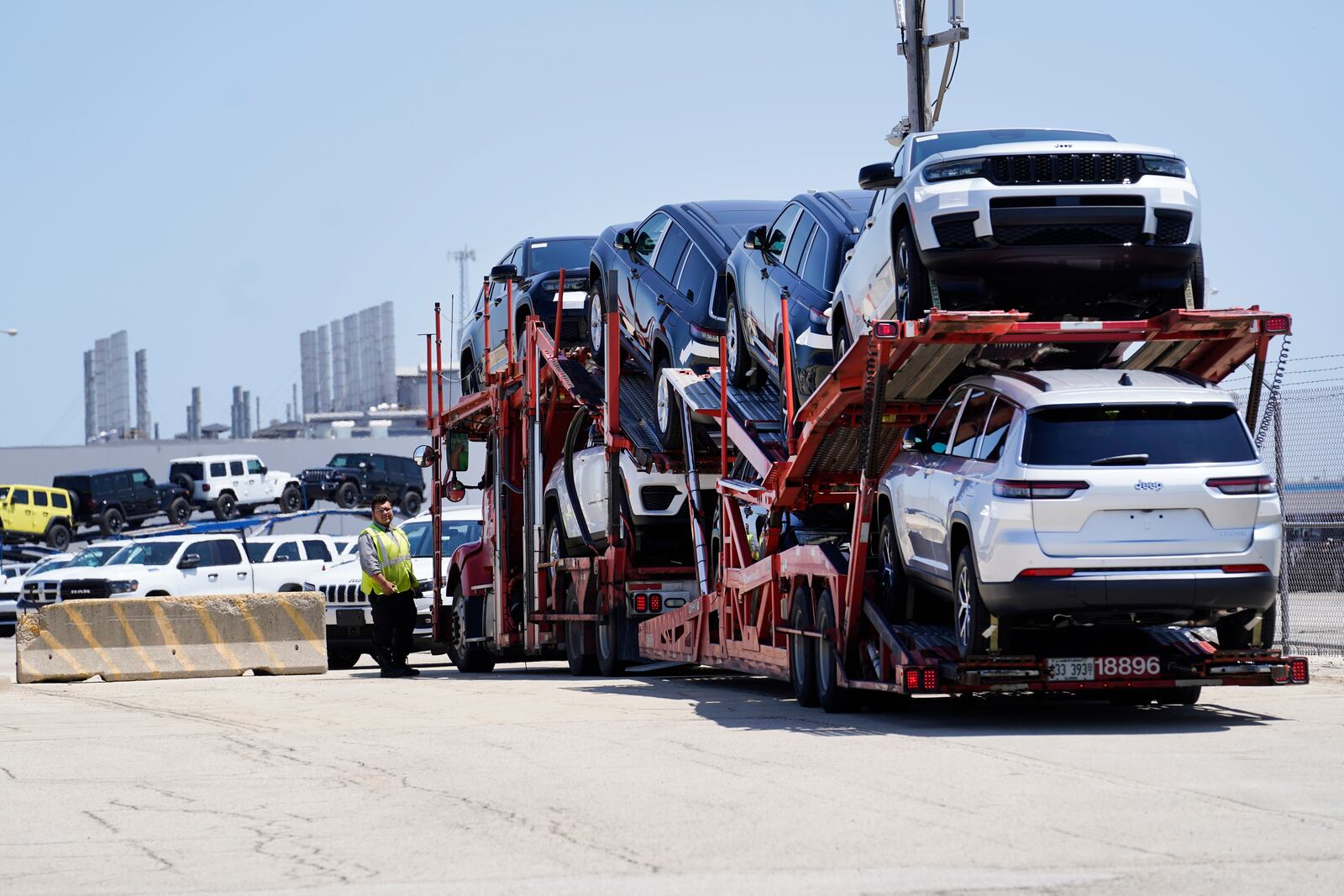 File - A truck loaded with new cars arrives arrives at the Stellantis Belvidere Assembly Plant on Monday, July 10, 2023, in Belvidere. Ill. (AP Photo/Charles Rex Arbogast, File)
