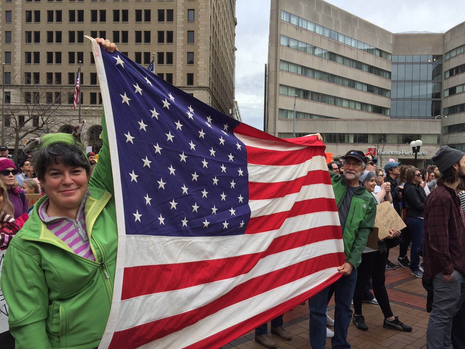 Lawrene and Darryl Trump of Riverside unfurl their flag at the Dayton's Women's Sister March rally at Courthouse Square in Dayton on Saturday.