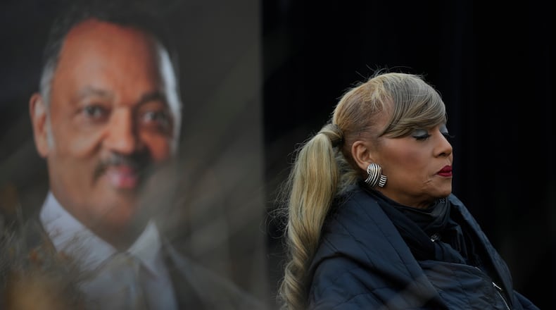 Santita Jackson stands near a picture of her father, the Rev. Jesse Jackson, during a news conference outside the family home Wednesday, Feb. 18, 2026, in Chicago. (AP Photo/Erin Hooley)