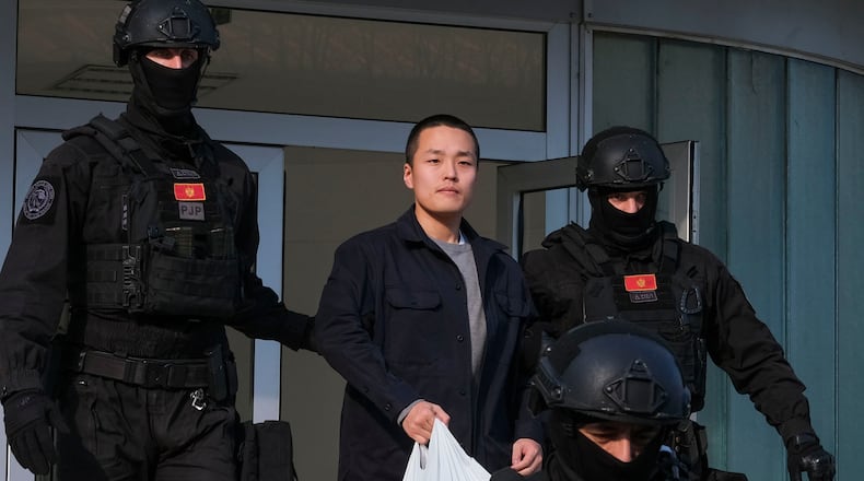 FILE - Montenegrin police officers escort South Korean citizen, Terraform Labs founder Do Kwon in Montenegro's capital Podgorica, March 23, 2024. (AP Photo/Risto Bozovic, File)