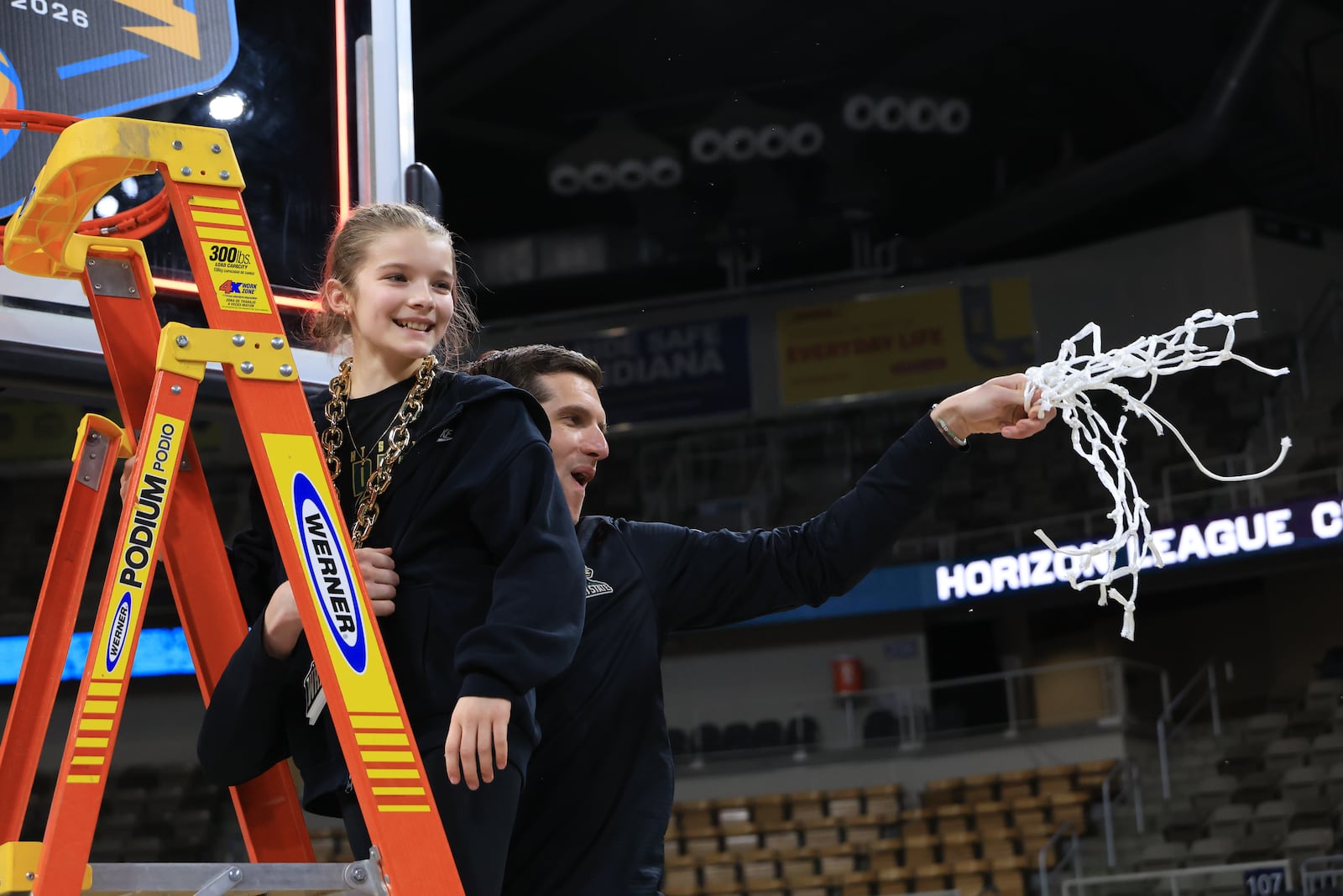 Wright State University Clint Sargent and his daughter, Gracie, cut down the net after their 66-63 victory over Detroit Mercy in the Horizon League tournament final on Tuesday, March 10, 2026 at Corteva Coliseum in Indianapolis. HORIZON LEAGUE / CONTRIBUTED PHOTO