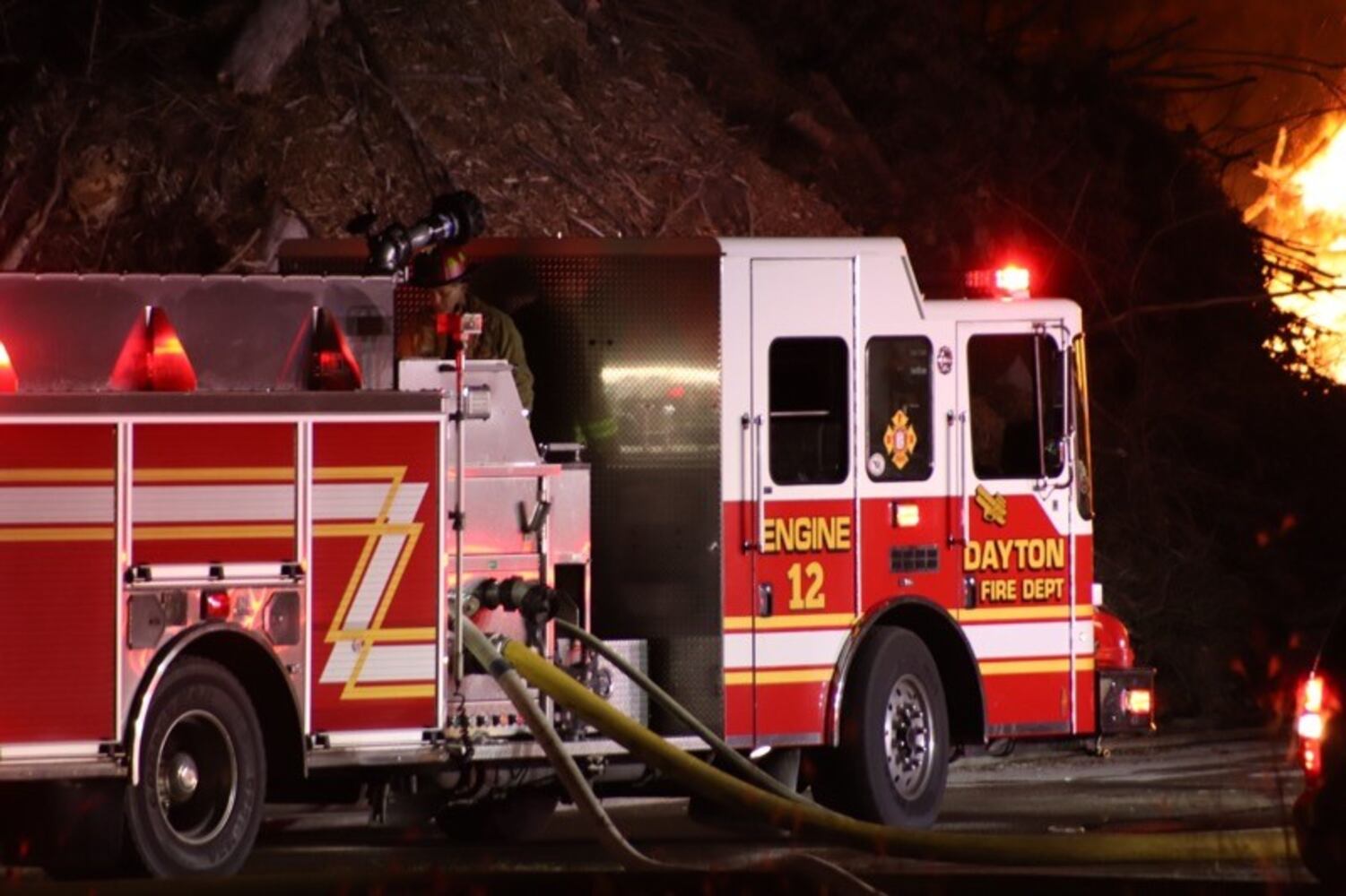 Fire crews battling huge fire in wood piles on Harshman Road