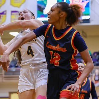 Cincinnati Purcell Marian's Lauryn Brown blocks a shot from Alter's Allison Link during a Division IV regional final on Saturday, March 7 at Vandalia-Butler's Student Activity Center. BRYANT BILLING / STAFF