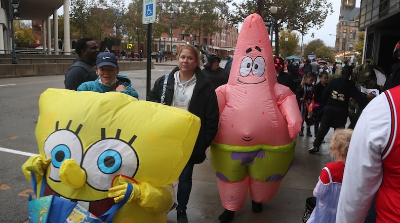 Characters of all types poured into downtown Springfield Friday evening for the annual Downtown Trick-or-Treat. Fountain Avenue was blocked off so thousands of children and their parents could go business to business for candy and other goodies. Several groups and politicians running for office also set up booths along the sidewalk to hand out candy. BILL LACKEY/STAFF