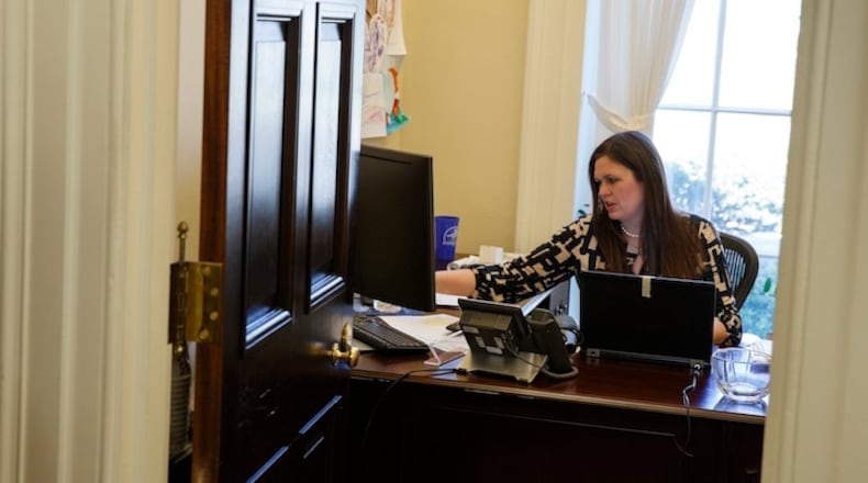 In this March 8, 2017, photo, White House deputy press secretary Sarah Huckabee Sanders works in her office at the White House in Washington. The 34-year-old spokeswoman for President Donald Trump was schooled in hardscrabble politics — and down-home rhetoric — from a young age by her father, folksy former Arkansas Gov. Mike Huckabee. Her way with a zinger, and her unshakable loyalty to an often unpredictable boss, is a big reason why the deputy press secretary is a rising star in Trump's orbit.  (AP Photo/Evan Vucci)