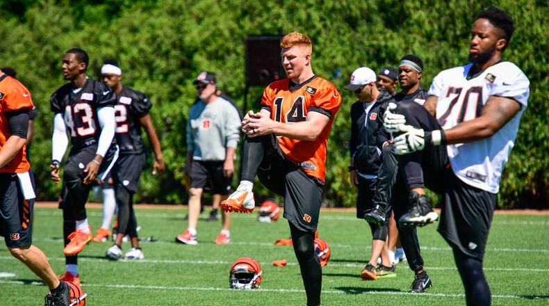 Cincinnati Bengals quarterback Andy Dalton (14) and offensive tackle Cedric Ogbuehi (70) stretch during practice Tuesday, June 6 on their practice fields next to Paul Brown Stadium in Cincinnati. NICK GRAHAM/STAFF