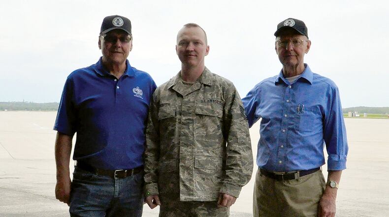 Charlie Hampton (left) stands with his son, Tech. Sgt. Robert Hampton, and brother, David Hampton, by the Wright-Patterson Air Force Base flightline where each of them served as a member of the 87th Aerial Port Squadron. (U.S. Air Force photo/2nd Lt. Rachel Ingram)