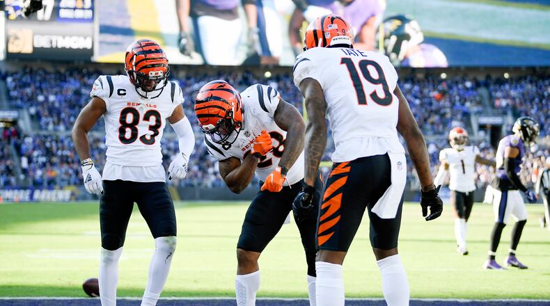 Cincinnati Bengals running back Joe Mixon, center, celebrates his touchdown run with wide receiver Tyler Boyd (83) and wide receiver Auden Tate (19) during the second half of an NFL football game against the Baltimore Ravens, Sunday, Oct. 24, 2021, in Baltimore. (AP Photo/Nick Wass)