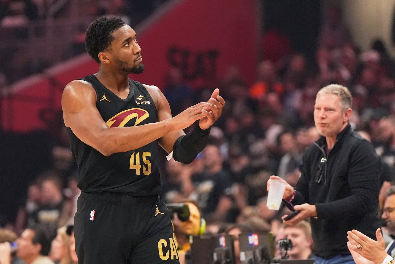 Cleveland Cavaliers guard Donovan Mitchell gestures to fans during the first half in Game 5 of an Eastern Conference semifinal NBA basketball playoff against the Indiana Pacers, Tuesday, May 13, 2025, in Cleveland. (AP Photo/Sue Ogrocki)