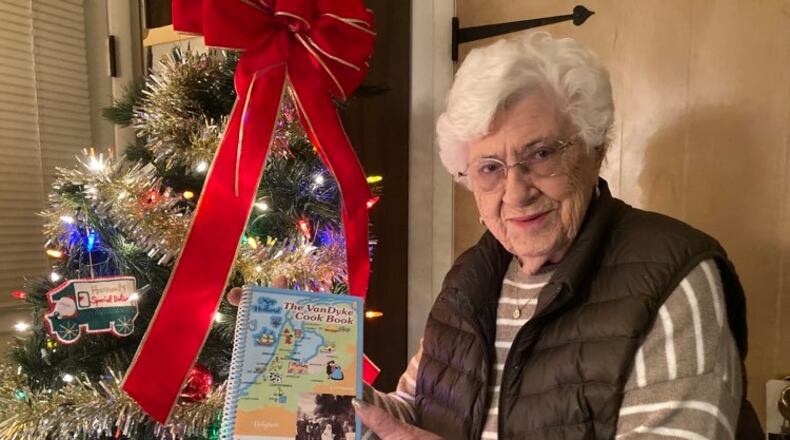Dorothy Frysinger with a copy of her family's cookbook, The VanDyke Cook Book.