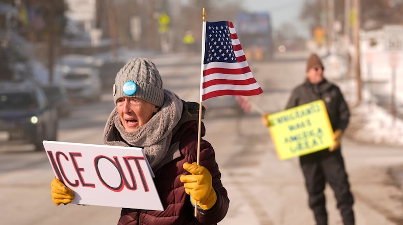 Rosie Grutze protests the presence of the U.S. Immigration and Customs Enforcement, Wednesday, Jan. 21, 2026, in Portland, Maine. (AP Photo/Robert F. Bukaty)