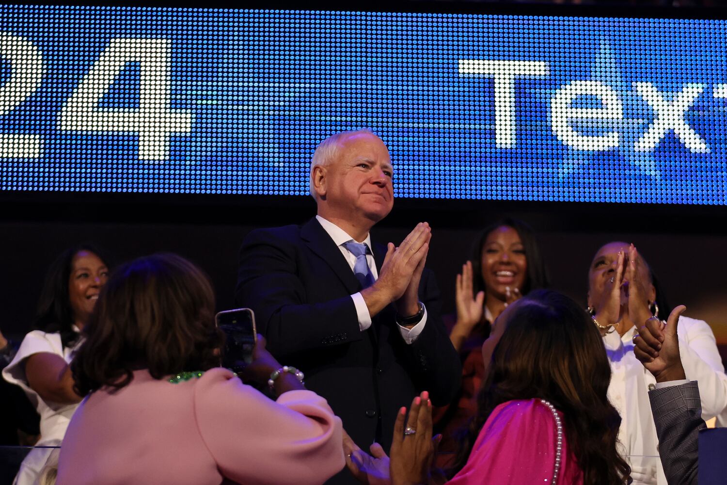 
                        Gov. Tim Walz of Minnesota, the Democratic vice presidential nominee, as Vice President Kamala Harris, the Democratic presidential nominee, speaks on the fourth day of the Democratic National Convention at the United Center in Chicago, on Thursday, Aug. 22, 2024. (Maddie McGarvey/The New York Times)
                      