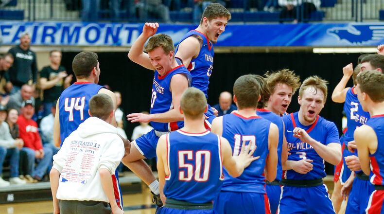 The Tri-Village High School boys basketball team celebrates after beating Botkins to win the Division IV regional championship on Friday night at Kettering's Trent Arena. CONTRIBUTED PHOTO BY MICHAEL COOPER