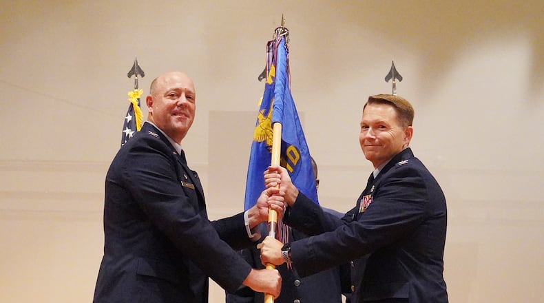 Col. Patrick Miller (left), then-88th Air Base Wing commander, passes the 88th Medical Group guidon to Col. Dale Harrell during an assumption of command ceremony July 7 at Wright-Patterson Air Force Base. Harrell previously served as the 78th Medical Group commander at Robins Air Force Base, Georgia. He assumes command from Col. Christian Lyons, who’s leaving for the Air Force Personnel Center in San Antonio. U.S. AIR FORCE PHOTO/KENNETH STILES