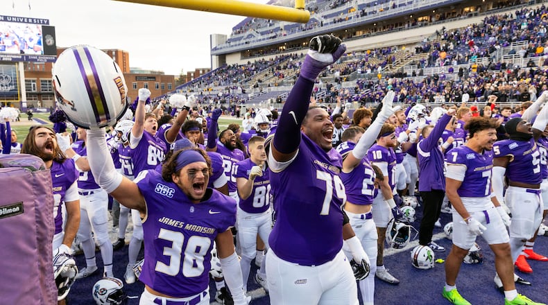 James Madison players celebrate defeating Washington State in an NCAA college football game, Saturday, Nov. 22, 2025, in Harrisonburg, Va. (AP Photo/Ryan M. Kelly)