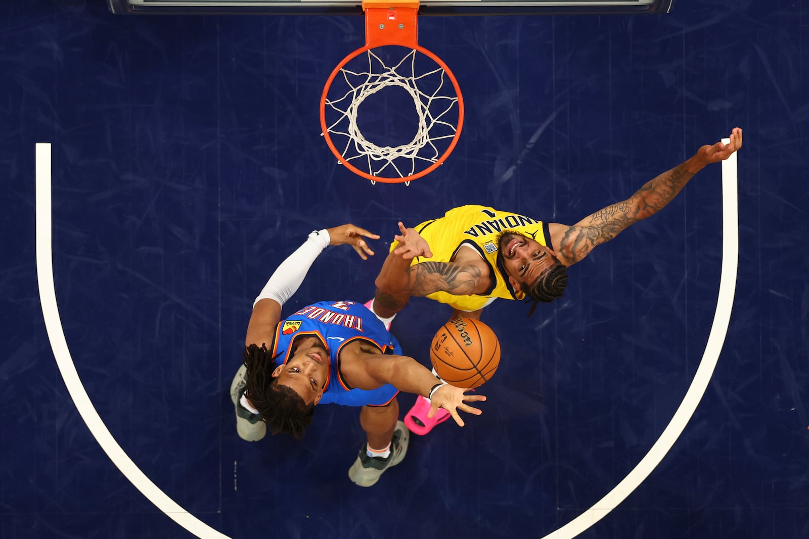 Oklahoma City Thunder forward Dillon Jones (3) Indiana Pacers forward Obi Toppin (1) fight for a rebound during the second half of Game 6 of the NBA Finals basketball series, Thursday, June 19, 2025, in Indianapolis. (Maddie Meyer/Pool Photo via AP)