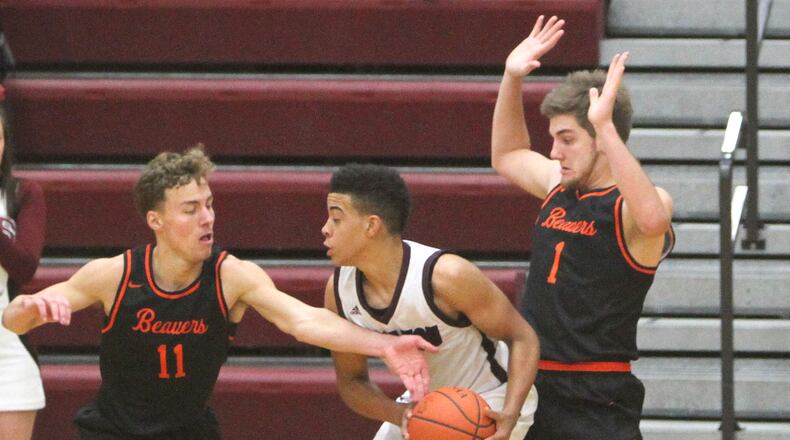 Lebanon’s Harrison Hookfin is guard by Beavercreek’s Jon Alessandro (11) and Adam Graeter during Friday night’s game at Lebanon. Randy Wimer/CONTRIBUTED