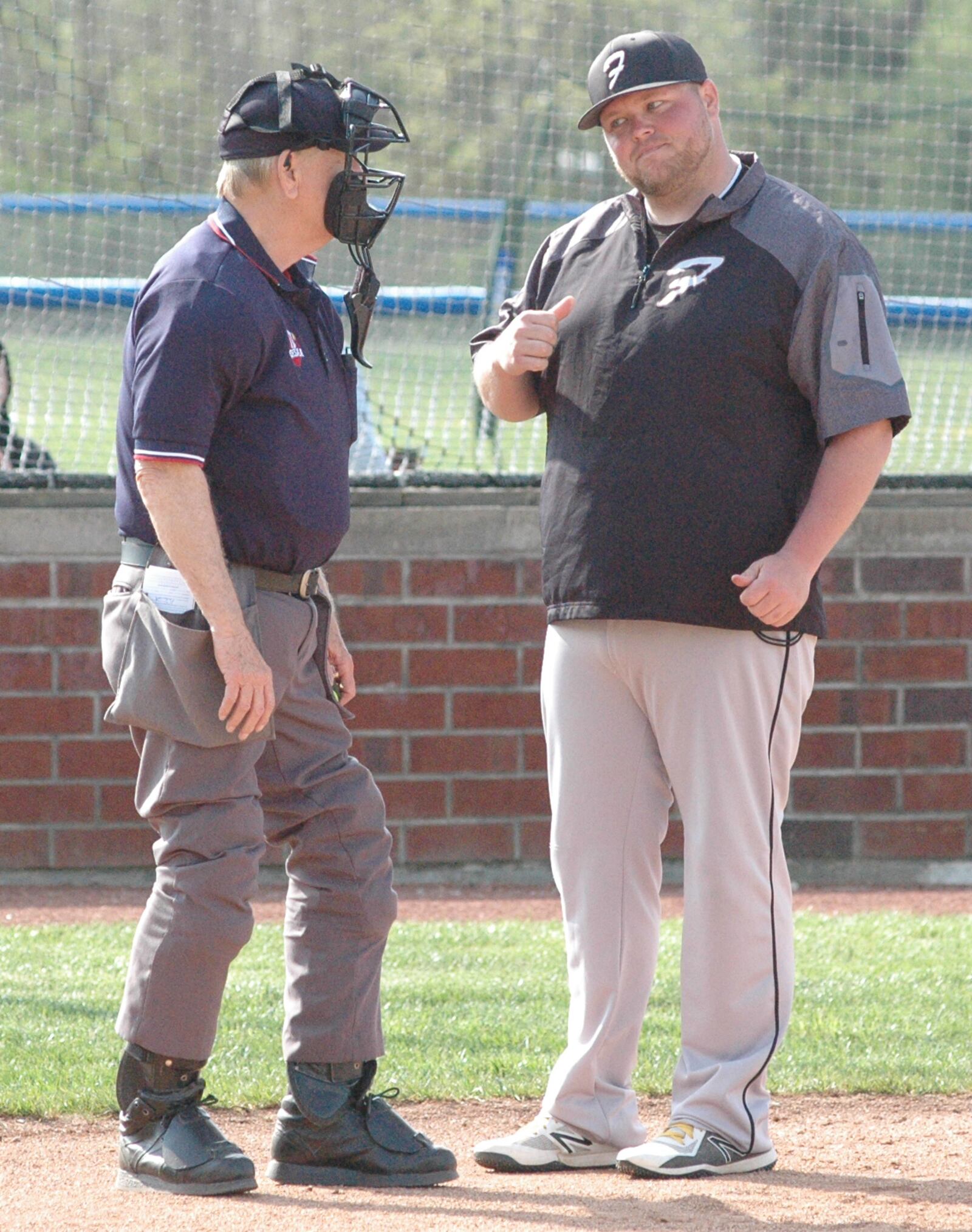 Franklin coach Kyle Wainscott questions a call during Tuesday’s 5-4 Southwestern Buckeye League Southwestern Division baseball loss at Brookville. RICK CASSANO/STAFF