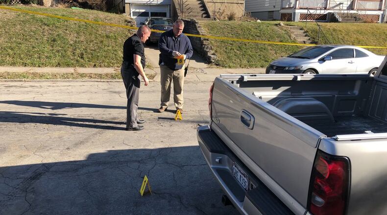Police examine the scene on Gilsey Avenue in West Price Hill where an 11-year-old girl was wounded during a shootout between two men on Christmas Day. Andrew Overton / WCPO