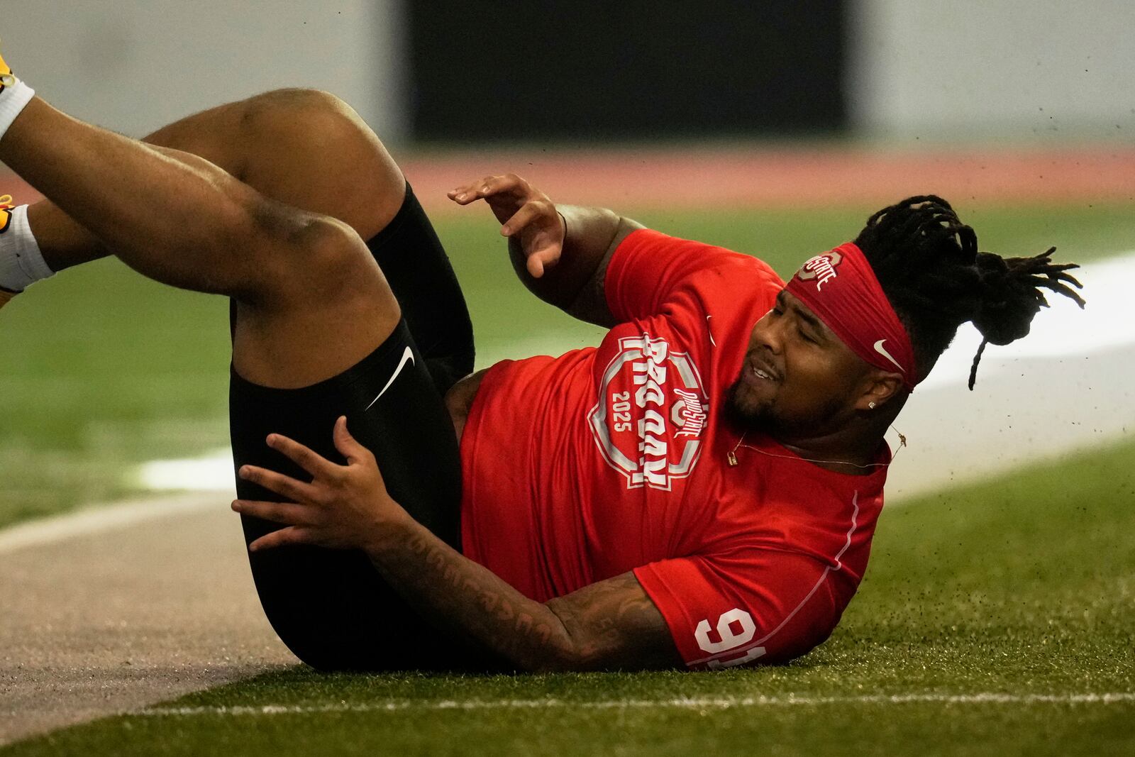 Ohio State's Tyleik Williams falls as he runs the 40-dash during the school's NFL football pro day, Wednesday, March 26, 2025, in Columbus, Ohio. (AP Photo/Sue Ogrocki)