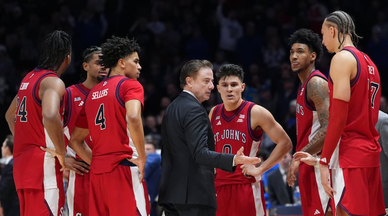 St. John's head coach Rick Pitino, center, instructs the team during a timeout in the second half of an NCAA college basketball game against Xavier, Saturday, Jan. 24, 2026, in Cincinnati. (AP Photo/Kareem Elgazzar)