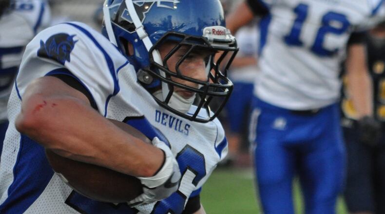 Brookville running back Bailey Wallen sizes up the defense during a first-quarter touchdown run against Oakwood on Thursday. NICK DUDUKOVICH / CONTRIBUTED