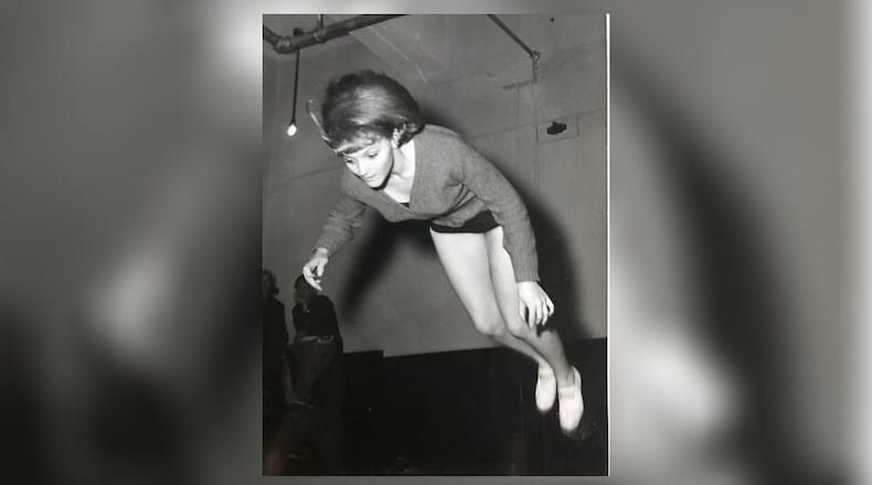 Charlotte Bowman flying through the air during a gymnastics workout at Stivers High School. CONTRIBUTED